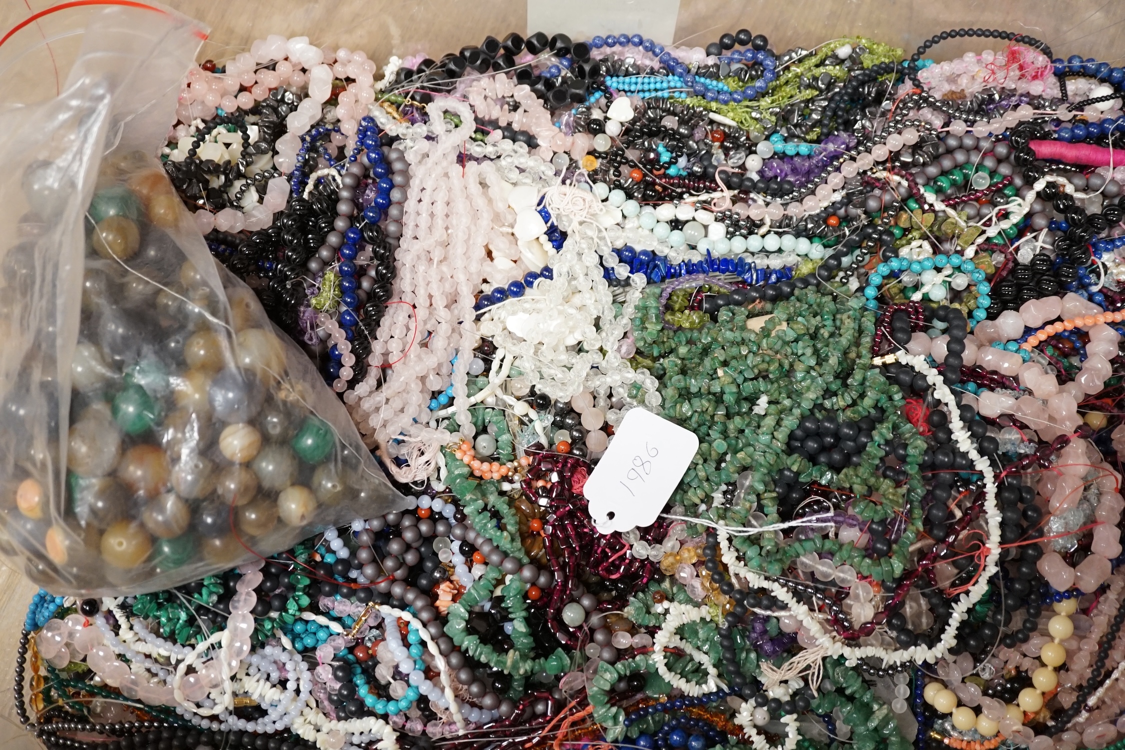 A large collection of in excess of three hundred bead necklaces and bracelets and a quantity of hardstone beads. Condition - poor to fair